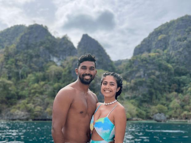 PADI AmbassaDivers Prachi and Harsh posing for a photo near the water.